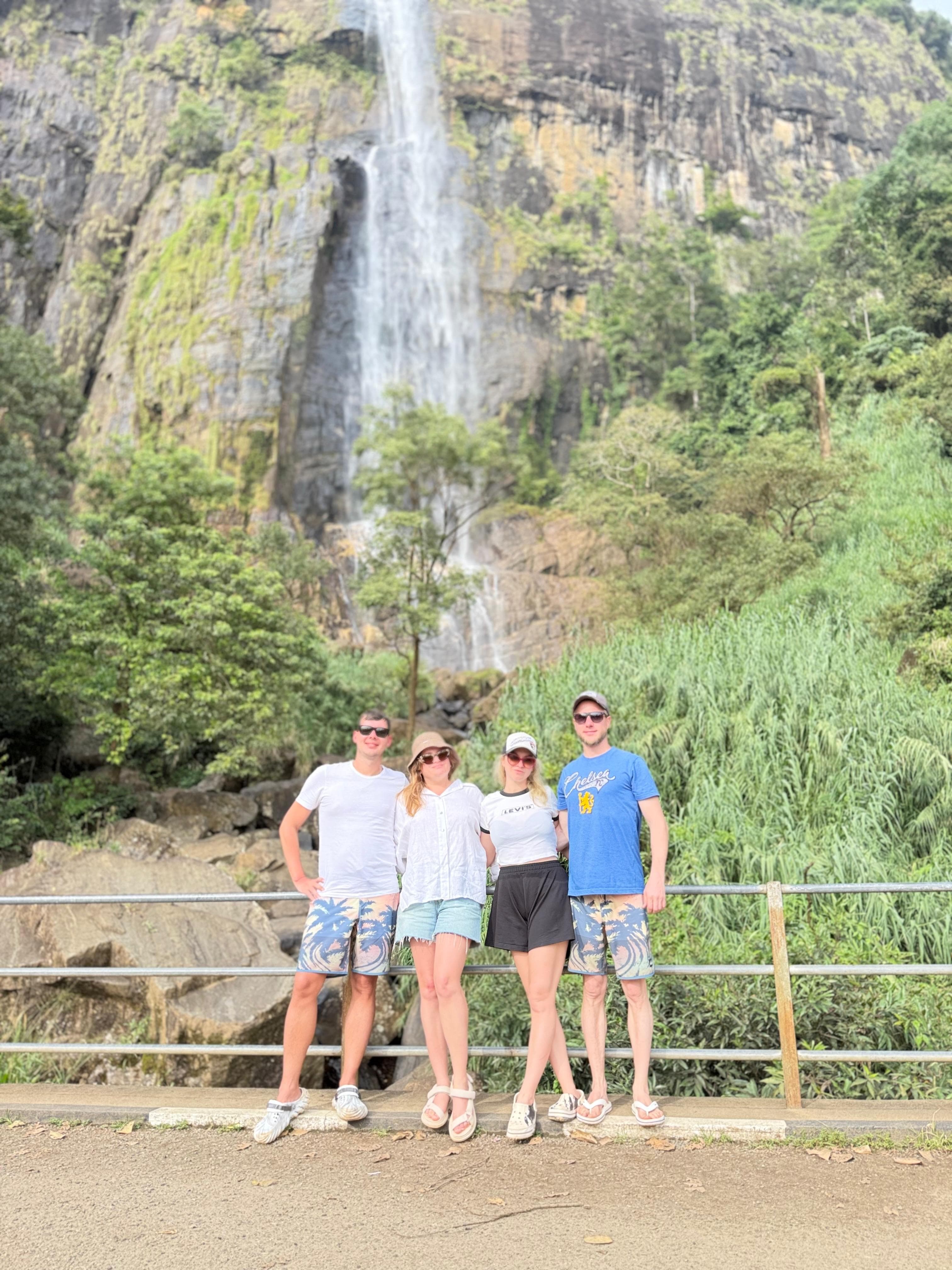Friends group at a waterfall cliff