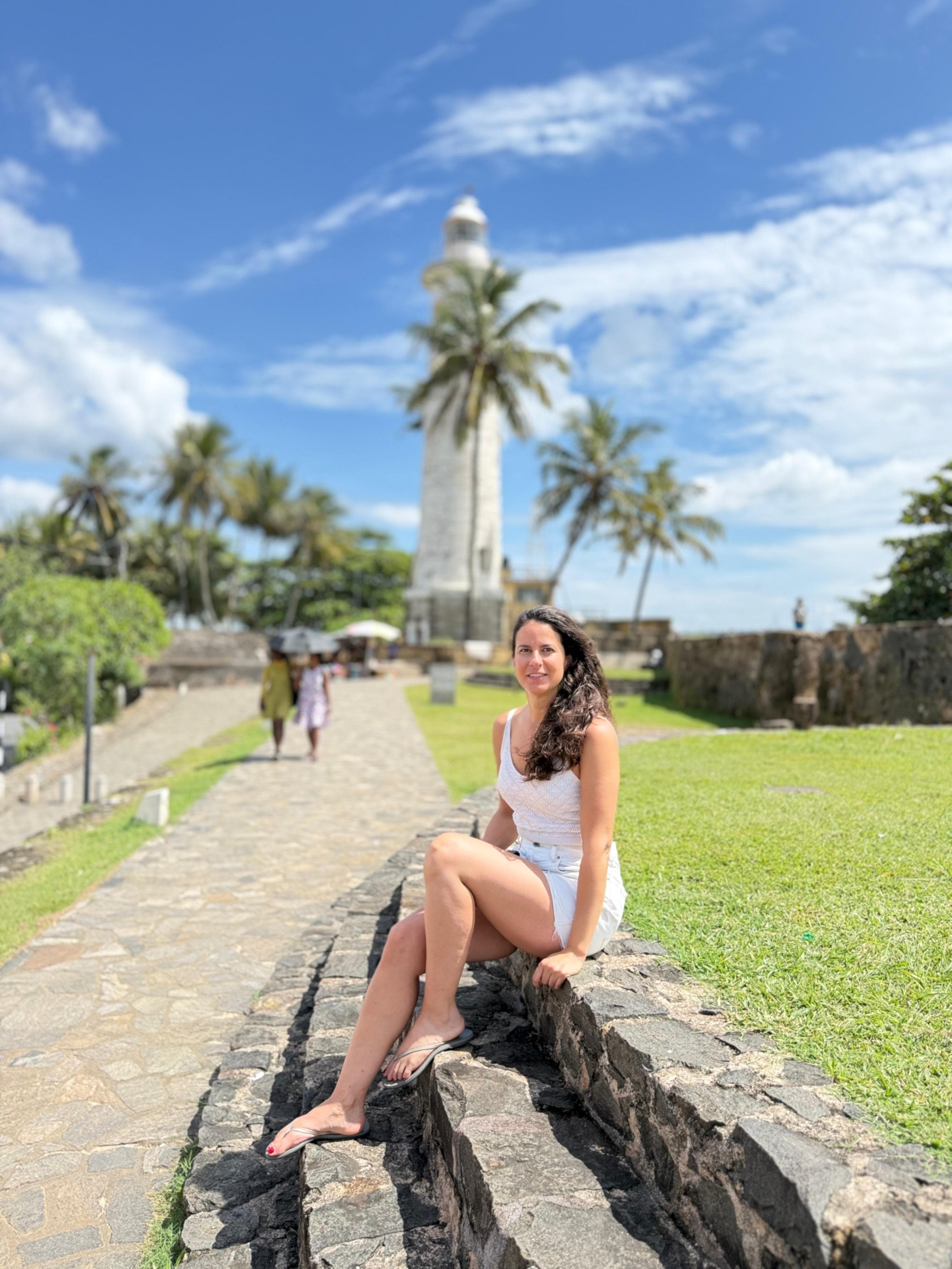 Galle Fort lighthouse framed by palm trees