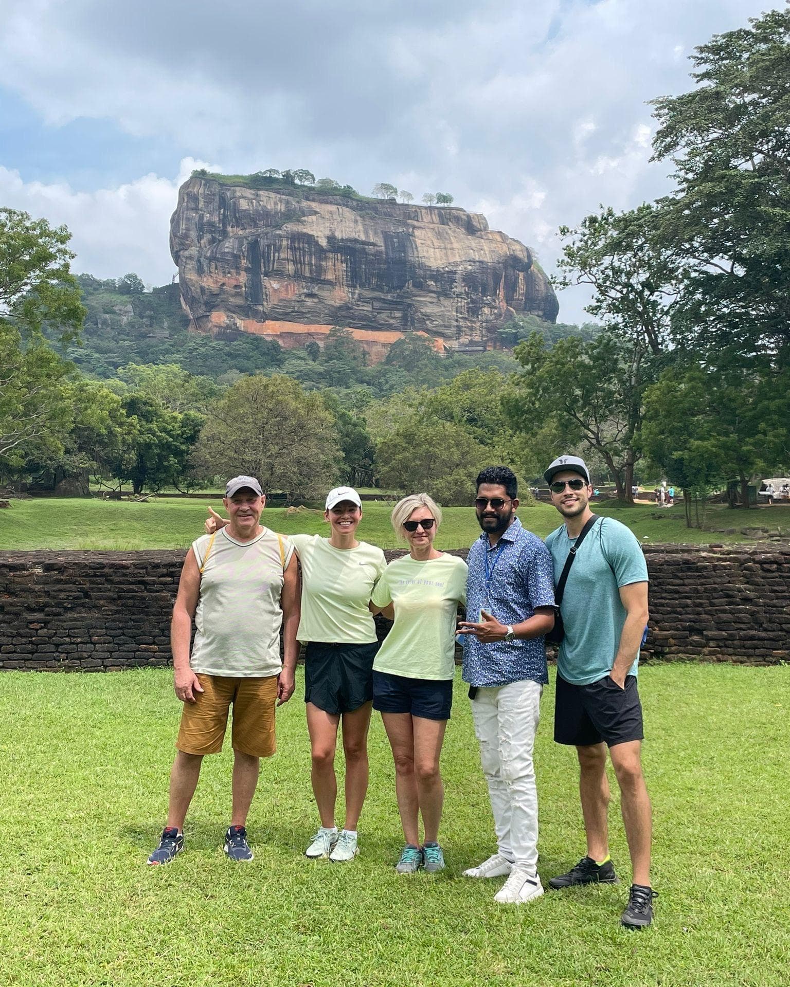 Group on the lawn at the base of Sigiriya rock fortress